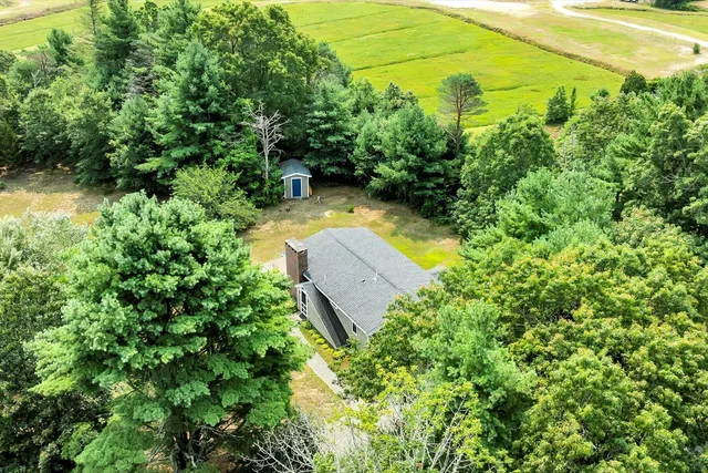 an aerial view of a house with a yard