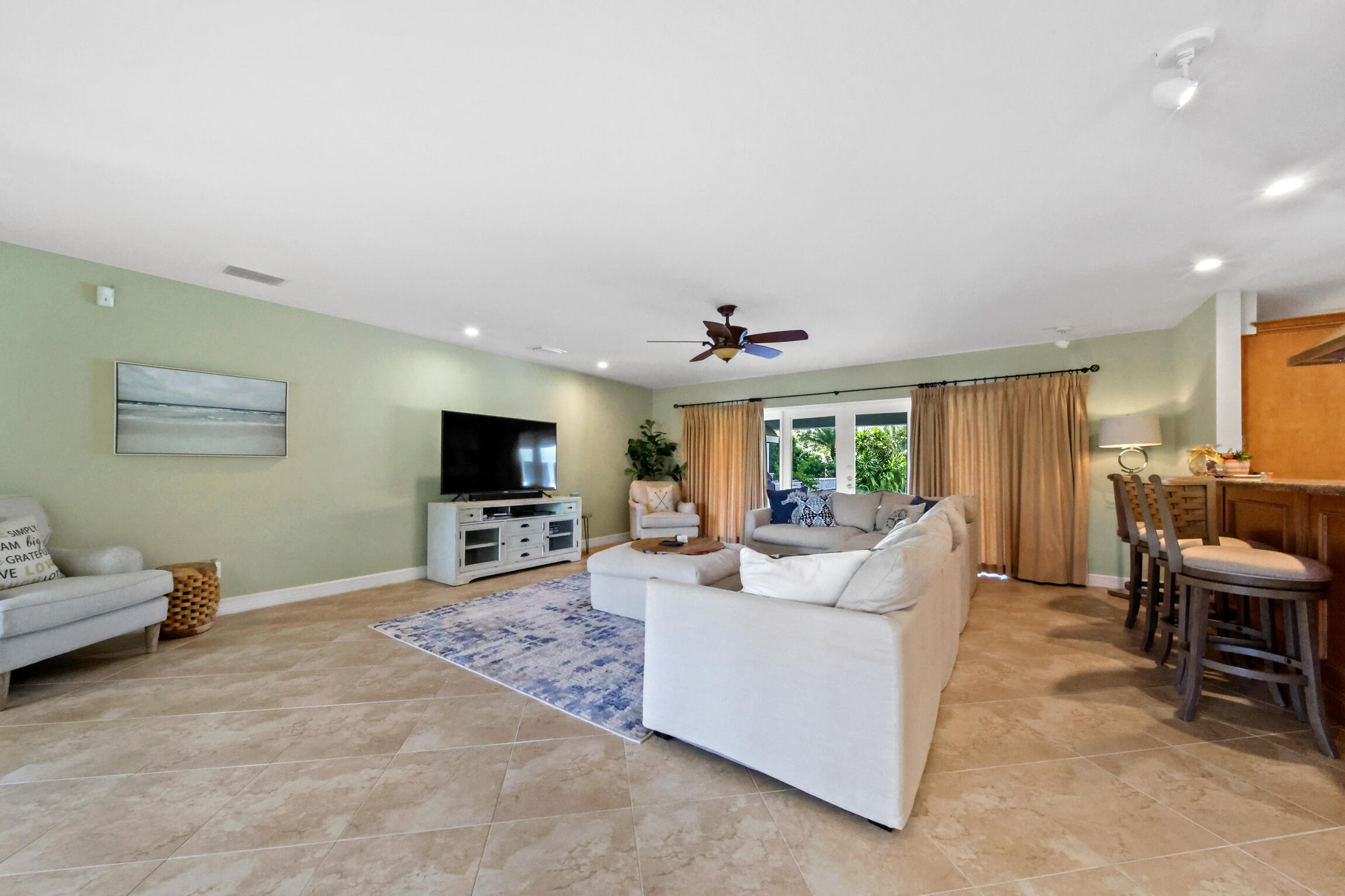 7 Island Road Sewall's Point, FL 34996 - Photo 25 of 70 a living room with furniture and a flat screen tv