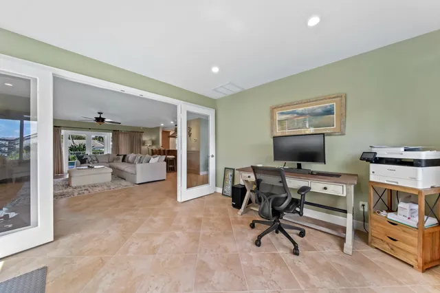 a living room with furniture a large window and a flat screen tv