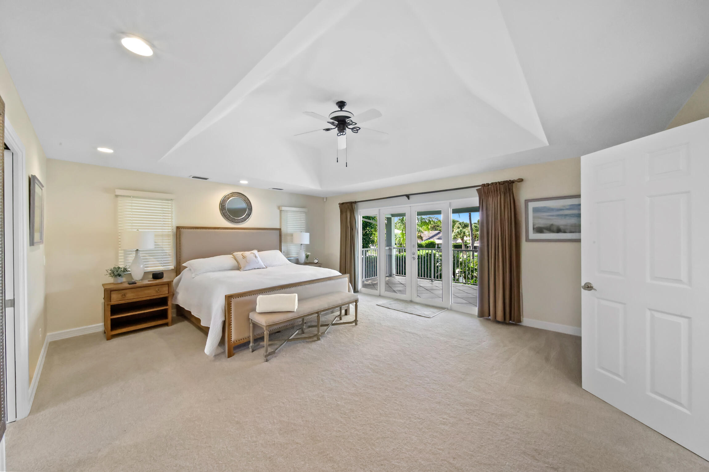 7 Island Road Sewall's Point, FL 34996 - Photo 28 of 70 a spacious bedroom with a bed and a large window