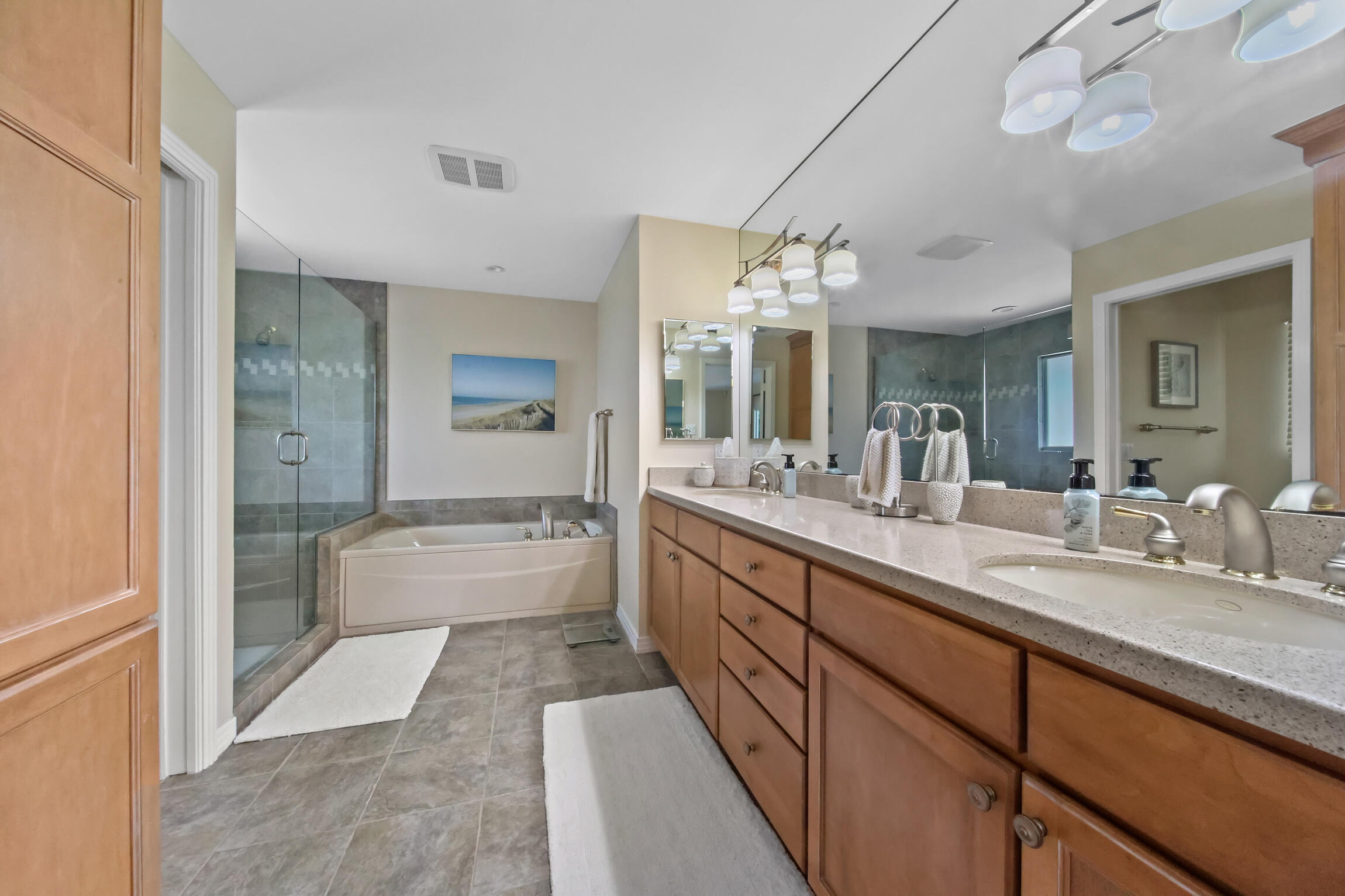 7 Island Road Sewall's Point, FL 34996 - Photo 30 of 70 a bathroom with a granite countertop sink mirror and bathtub