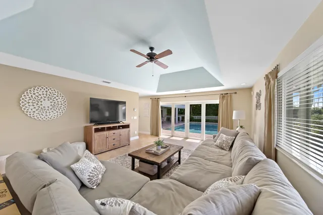 a spacious bedroom with a bed and a chandelier
