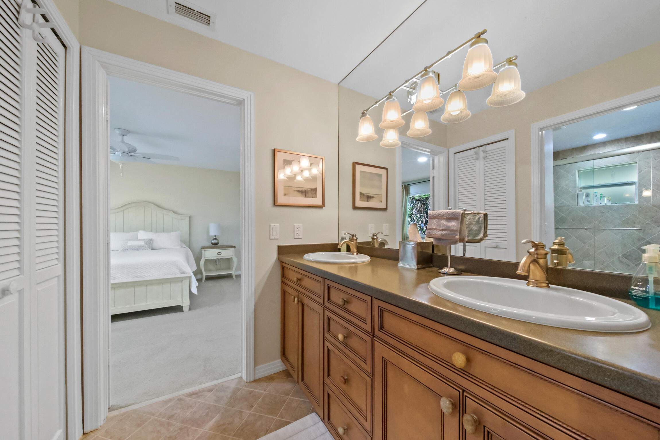 7 Island Road Sewall's Point, FL 34996 - Photo 40 of 70 a en suite bathroom with double sink and a mirror