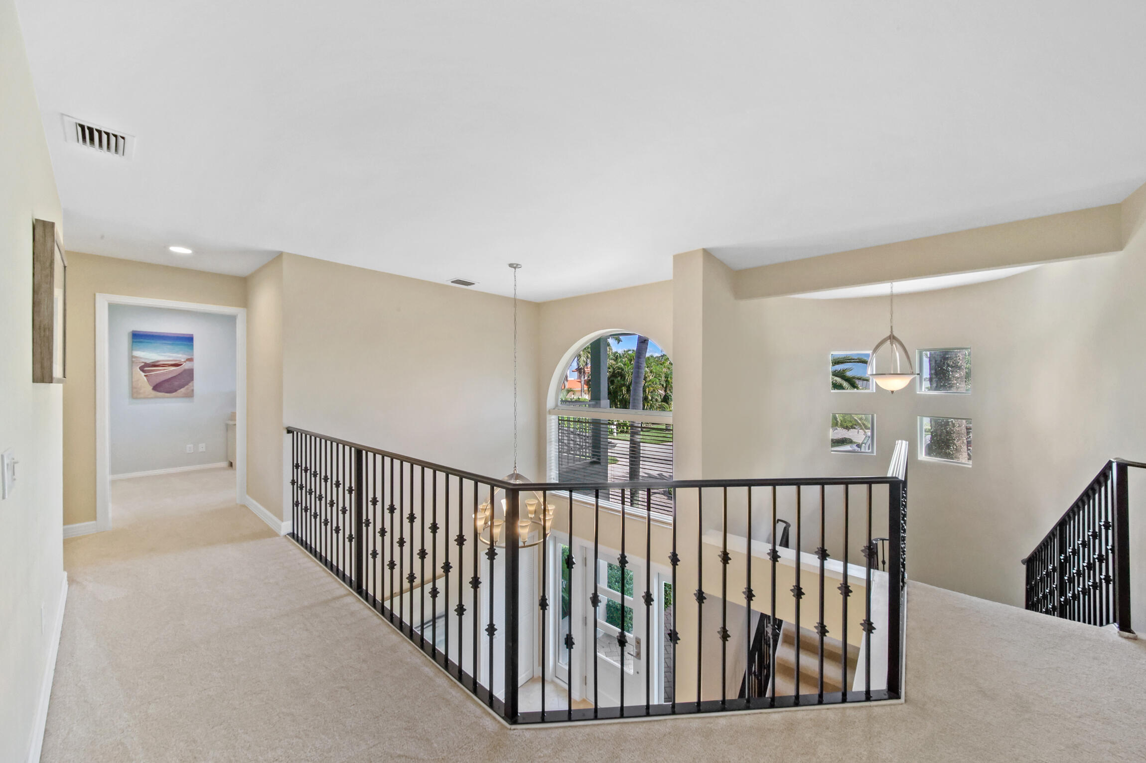 7 Island Road Sewall's Point, FL 34996 - Photo 43 of 70 a view of staircase with lots of frames on wall and a window