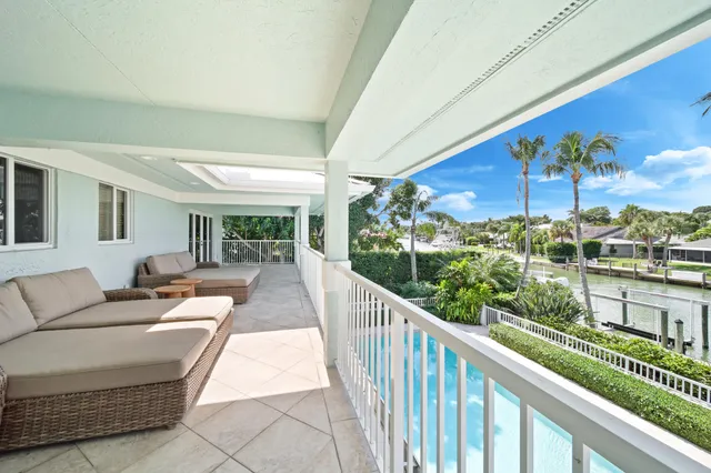an aerial view of residential houses with outdoor space and lake view