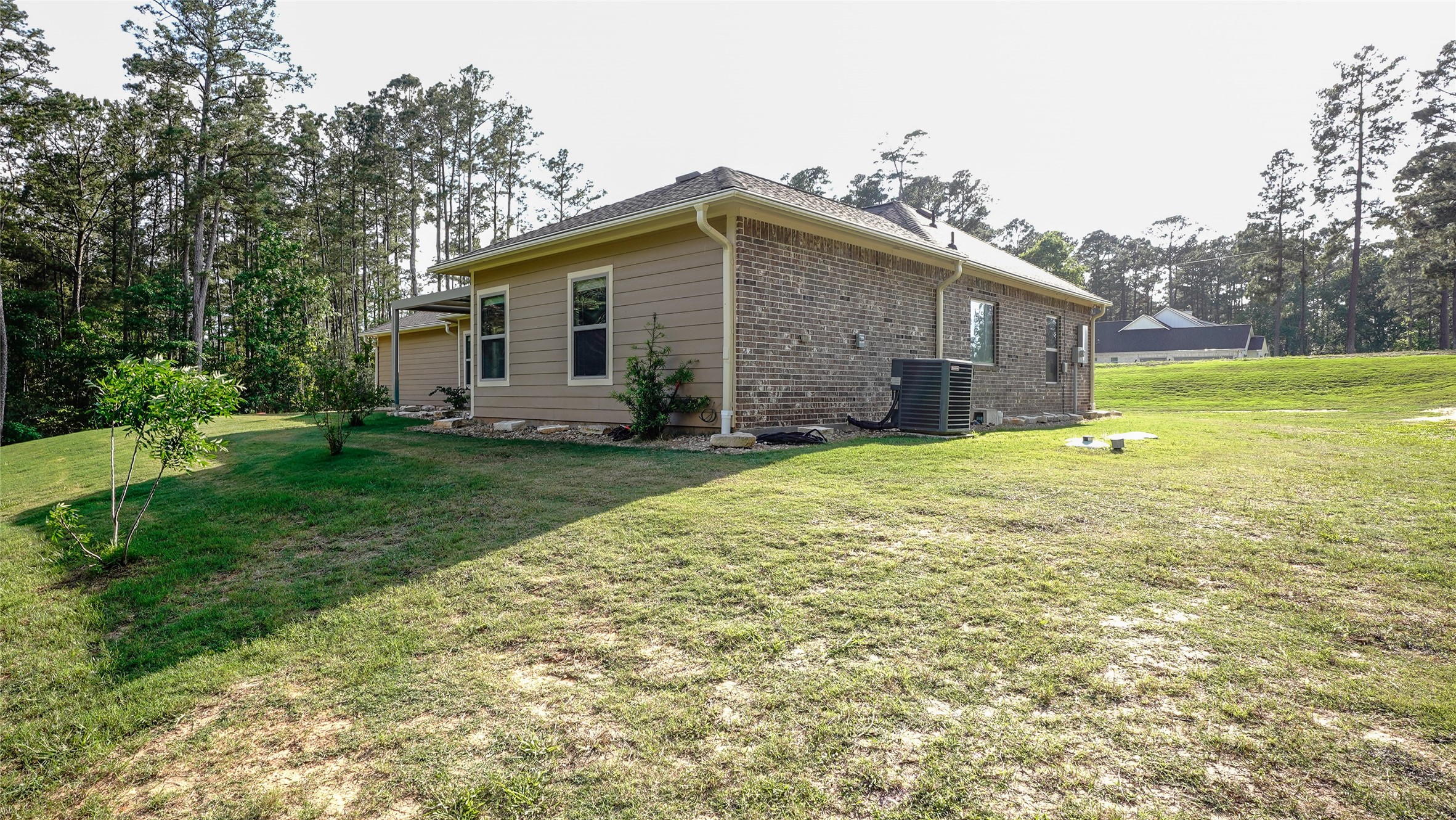 120 Sanctuary Road Huntsville, TX 77340 - Photo 29 of 38 a view of a house with a yard and trees