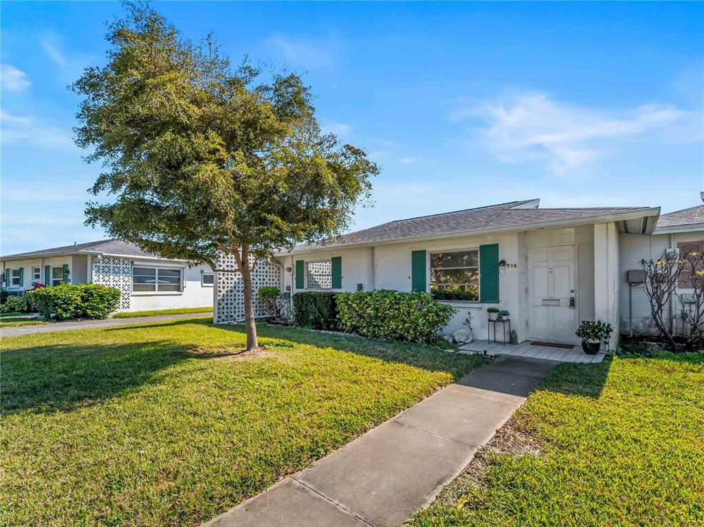116 The Corso, Unit 116 Venice, FL 34285 - Photo 1 of 36 a front view of a house with garden