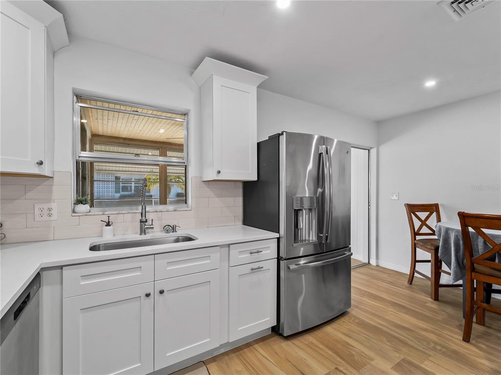 116 The Corso, Unit 116 Venice, FL 34285 - Photo 11 of 36 a kitchen with stainless steel appliances a refrigerator sink and cabinets