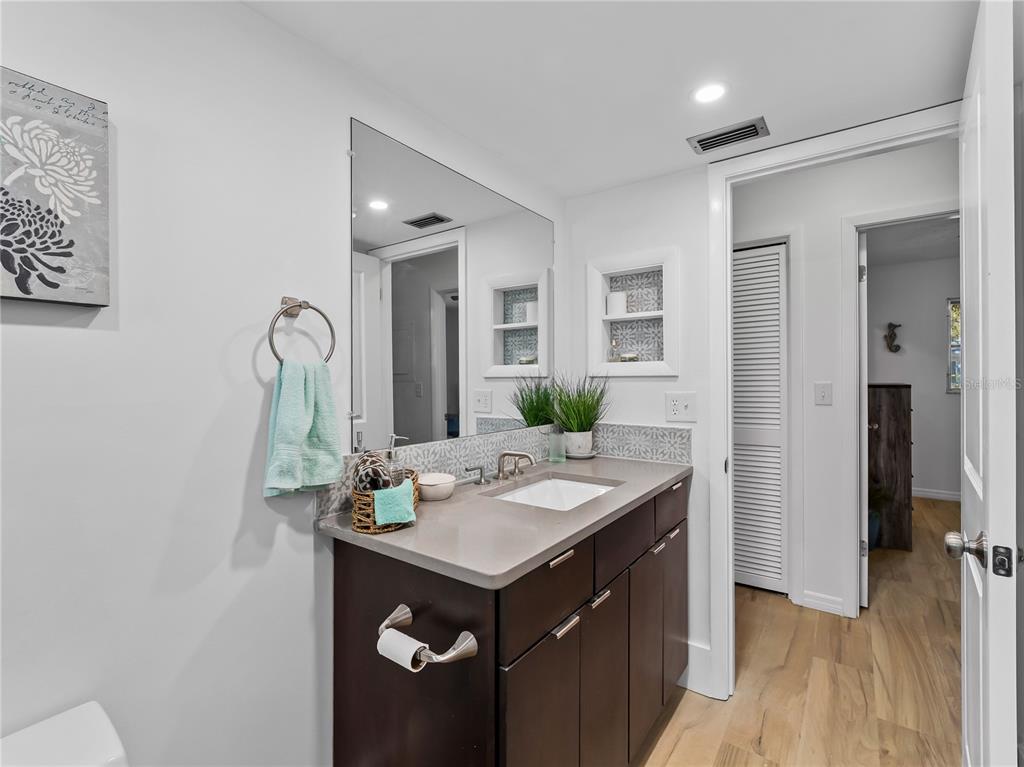116 The Corso, Unit 116 Venice, FL 34285 - Photo 14 of 36 a bathroom with a sink and a mirror