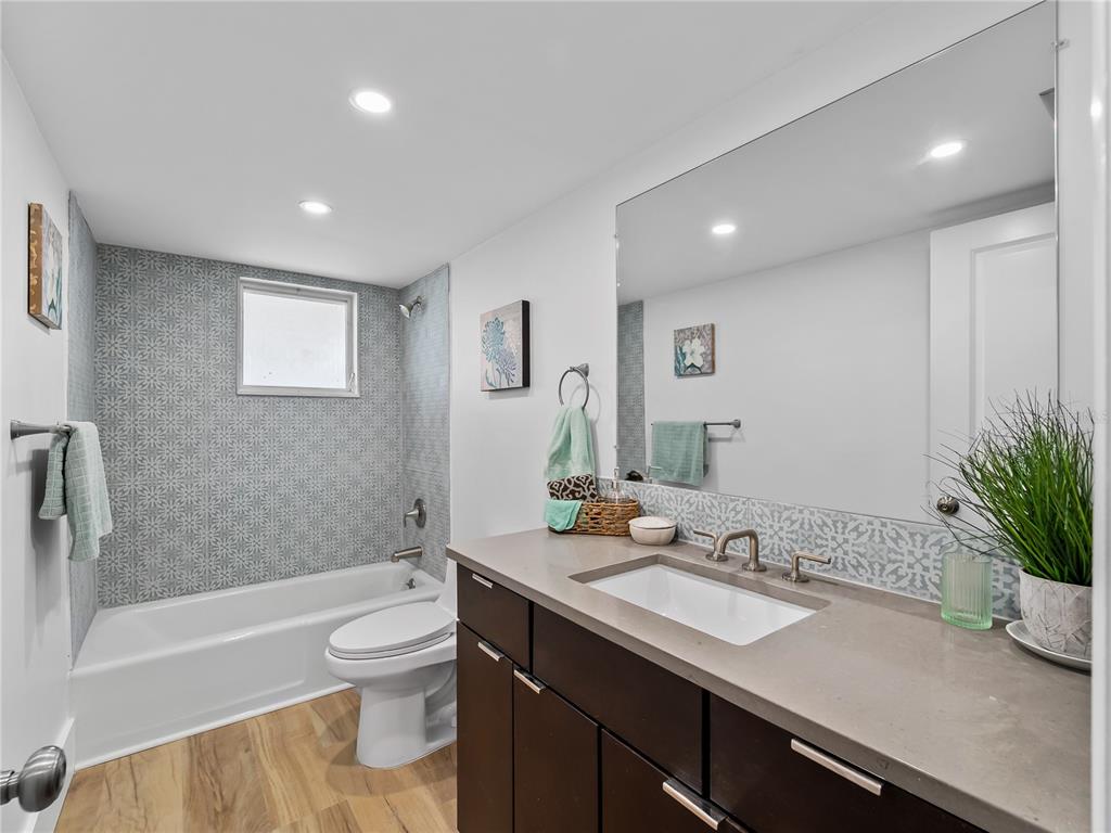 116 The Corso, Unit 116 Venice, FL 34285 - Photo 15 of 36 a bathroom with a sink a toilet and tub