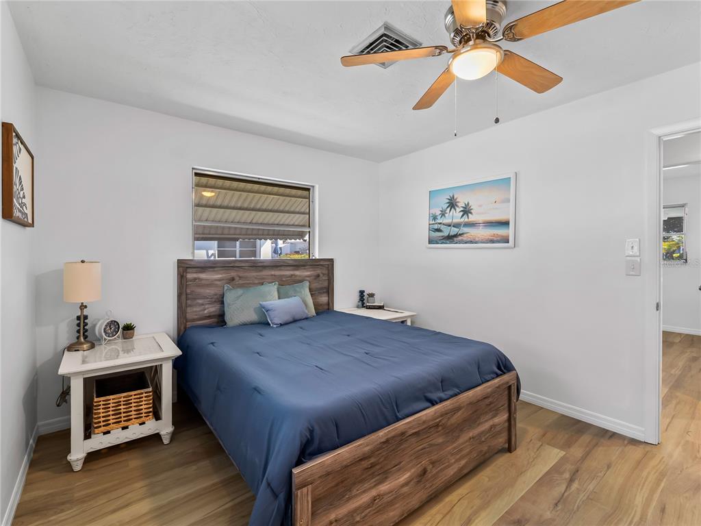 116 The Corso, Unit 116 Venice, FL 34285 - Photo 19 of 36 a bedroom with a bed and a chandelier