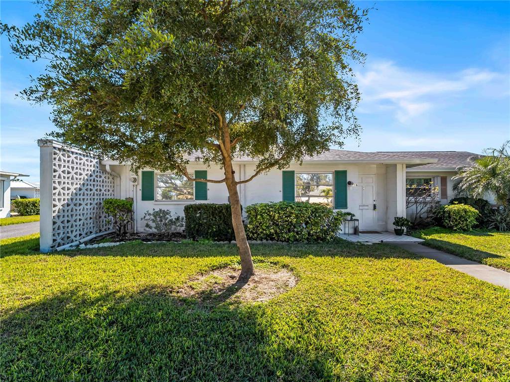 116 The Corso, Unit 116 Venice, FL 34285 - Photo 2 of 36 a view of a house with swimming pool and a yard