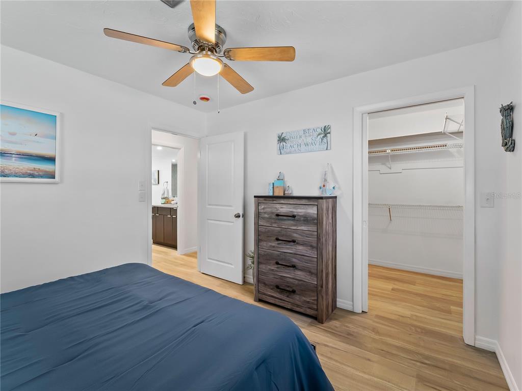 116 The Corso, Unit 116 Venice, FL 34285 - Photo 21 of 36 a bedroom with a bed and a dresser