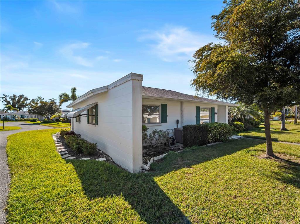 116 The Corso, Unit 116 Venice, FL 34285 - Photo 29 of 36 a view of a house with backyard and garden