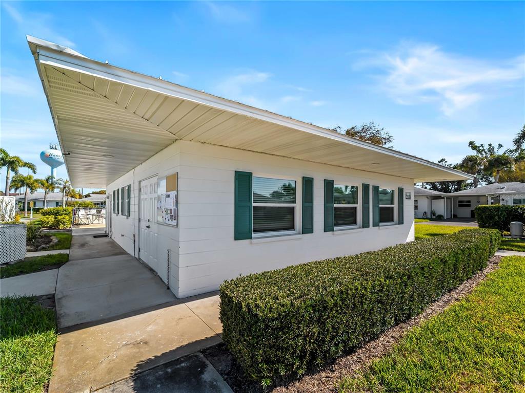 116 The Corso, Unit 116 Venice, FL 34285 - Photo 30 of 36 a front view of a house with a yard