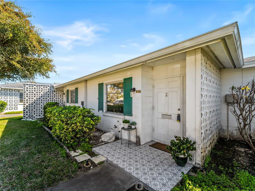 116 The Corso, Unit 116 Venice, FL 34285 - Photo 3 of 36 a front view of a house with garden