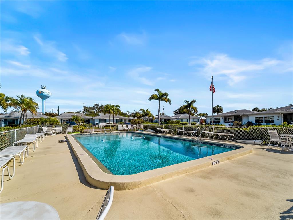 116 The Corso, Unit 116 Venice, FL 34285 - Photo 32 of 36 a view of a swimming pool with outdoor seating