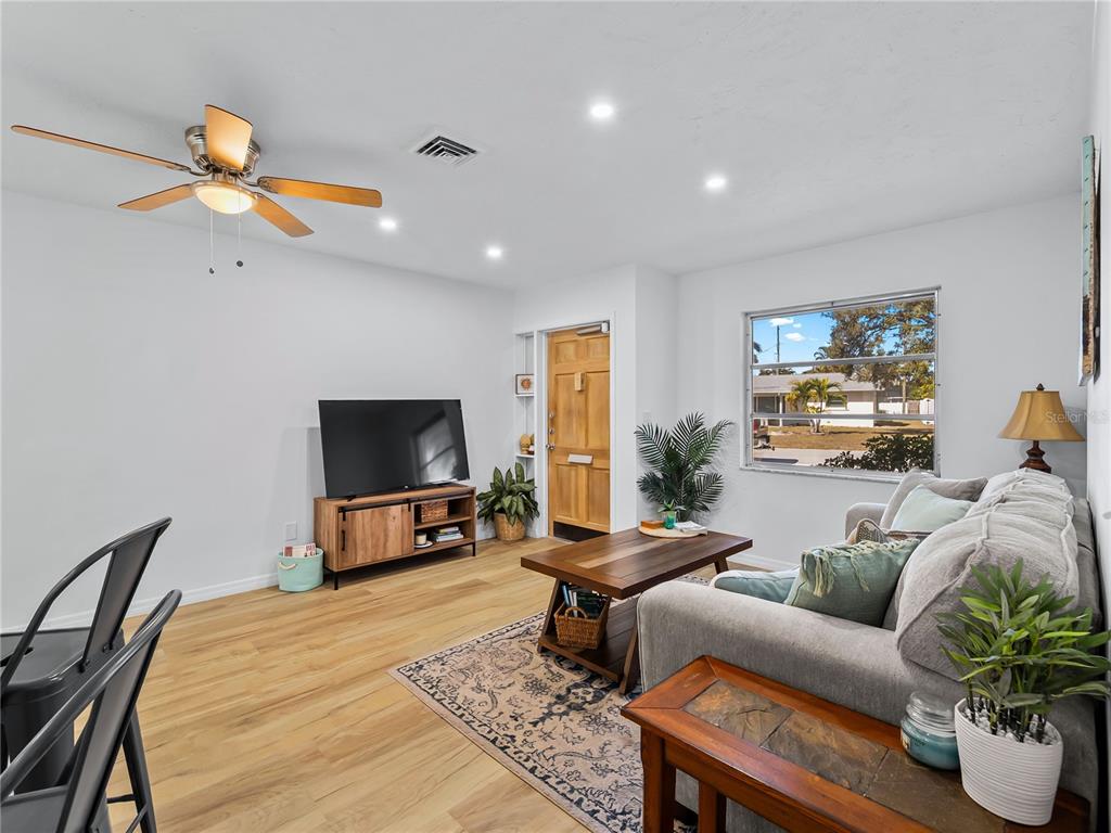116 The Corso, Unit 116 Venice, FL 34285 - Photo 6 of 36 a living room with furniture and a flat screen tv