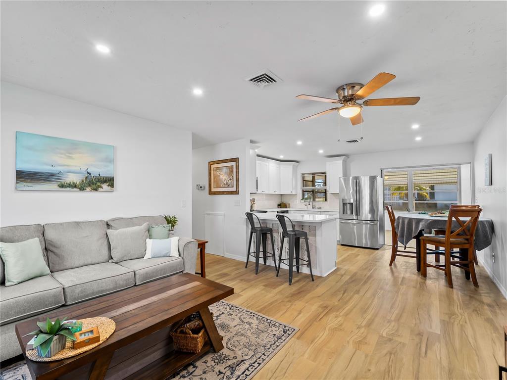 116 The Corso, Unit 116 Venice, FL 34285 - Photo 8 of 36 a living room with furniture and wooden floor