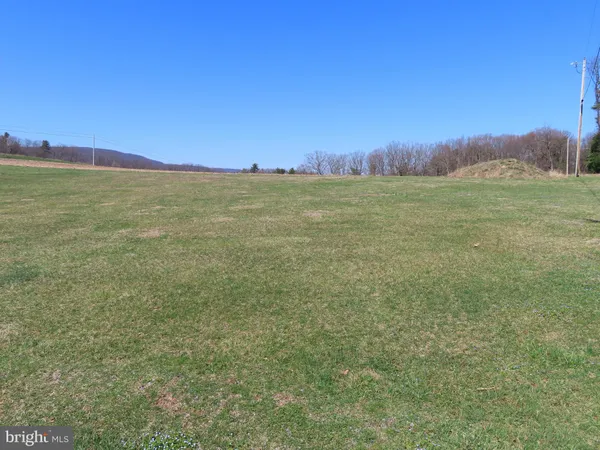 a view of a field with tree in the background