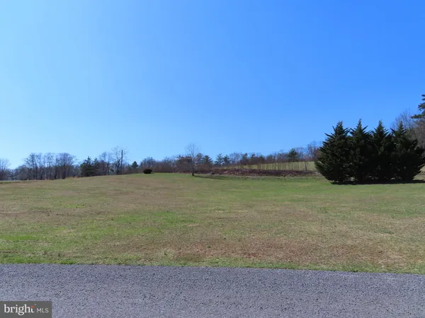 a view of field with trees in the background