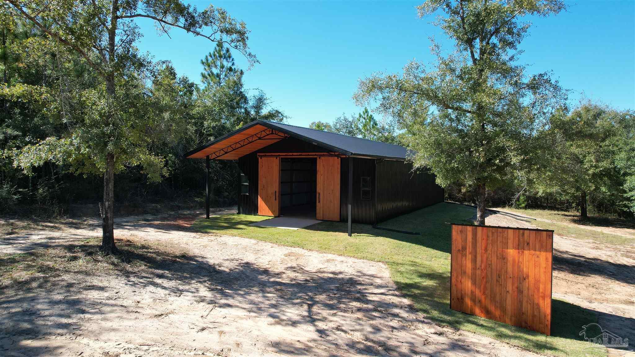 3404 YELLOW HAMMER Road Pace, FL 32571 - Photo 18 of 20 a backyard of a house with yard and tree