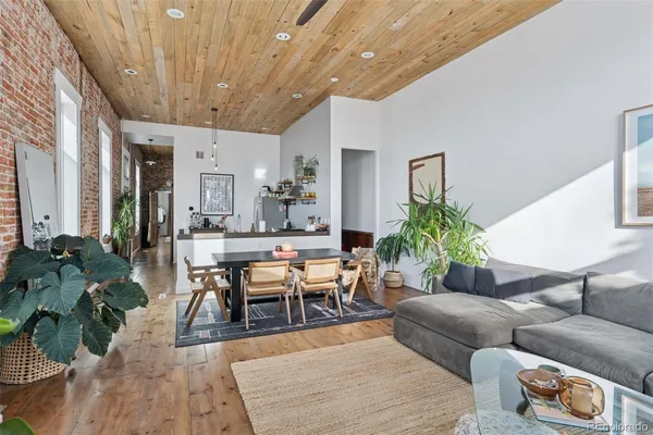 a living room with furniture potted plant and a chandelier