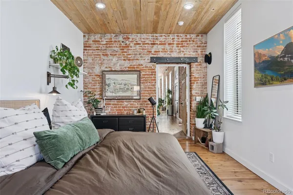 a bedroom with a bed and a potted plant