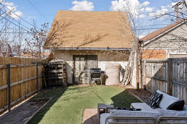 a view of a chairs and table in backyard