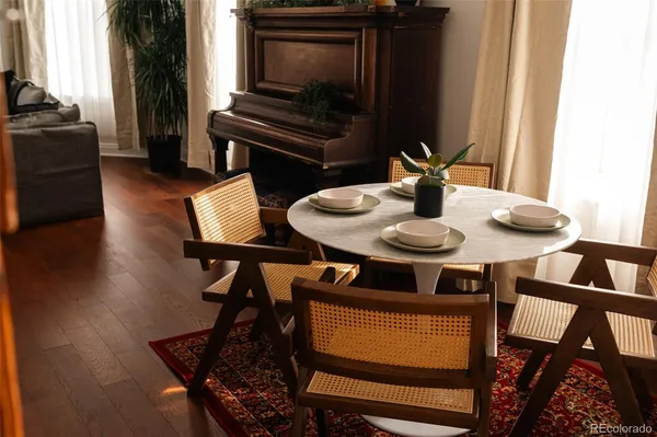 a view of a dining room with furniture and wooden floor