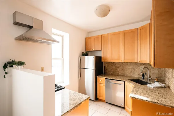 a kitchen with a refrigerator sink stove and cabinets