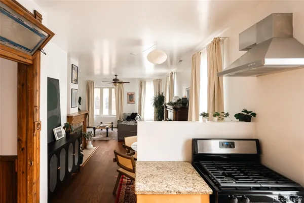 a very nice looking room with wooden floor and furniture