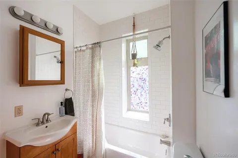 a bathroom with a sink a mirror and a shower