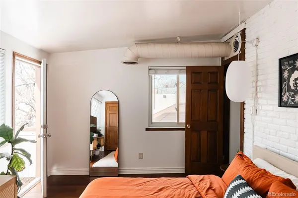 a bedroom with double bed and a window