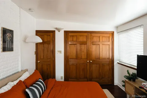 a bedroom with a bed and a cabinet