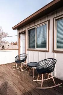 a balcony with table and chairs