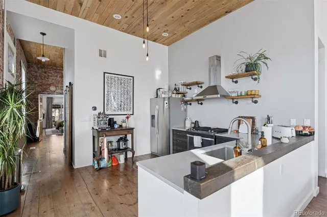 a kitchen with sink refrigerator and stove