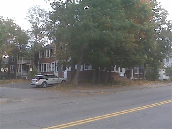 a view of street with parked cars