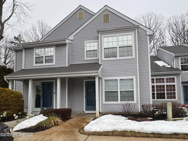 a front view of a house with a yard and glass windows