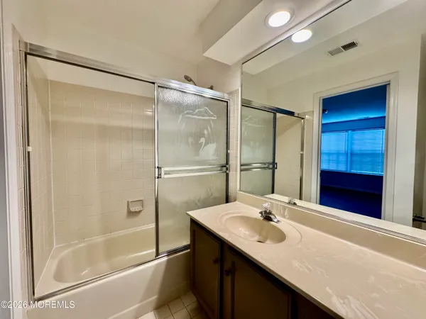 a bathroom with a tub a toilet and a shower