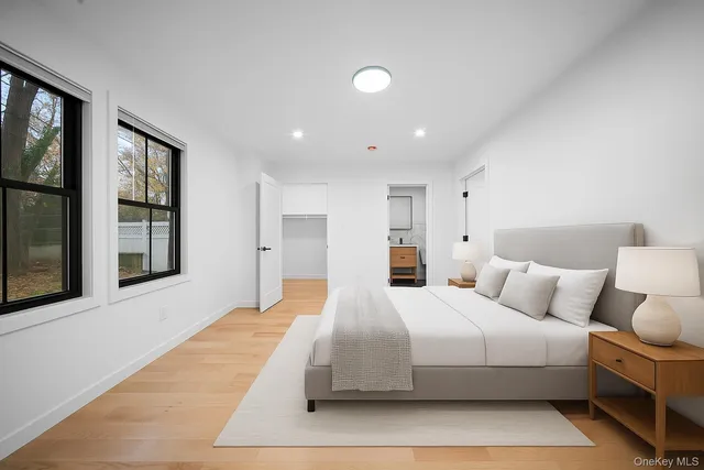 a bedroom with a large bed and a night stand