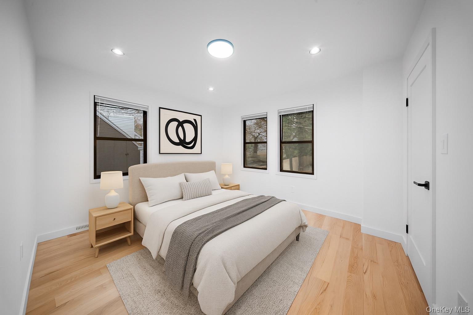 218-37 Spencer Avenue Queens, NY 11427 - Photo 21 of 31 Bedroom featuring light wood-type flooring, recessed lighting, and multiple windows