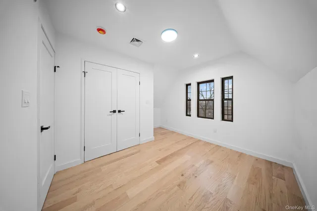 a view of empty room with window and ceiling fan