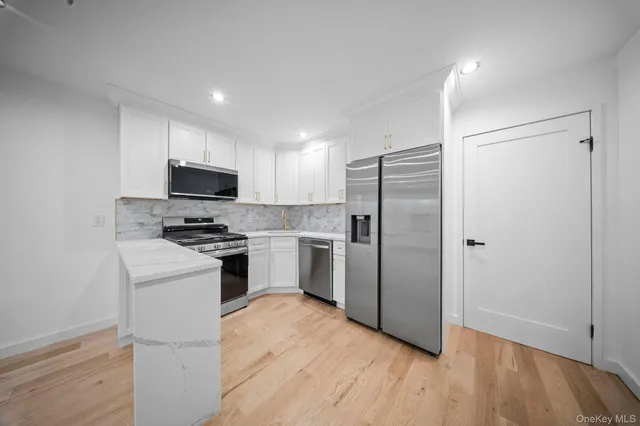 a kitchen with a refrigerator sink and microwave