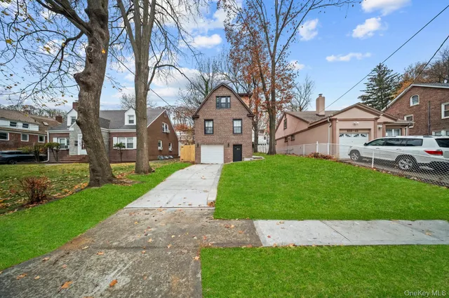a view of house with yard and green space