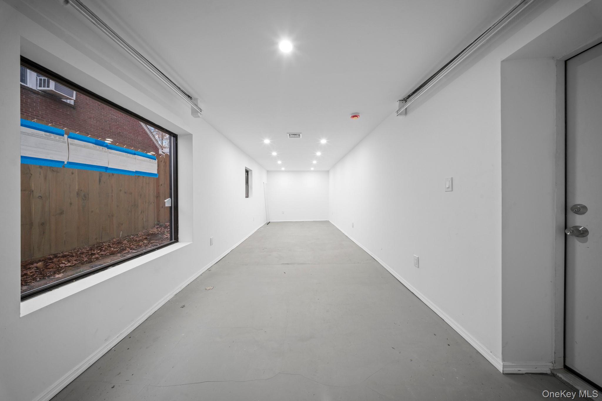 218-37 Spencer Avenue Queens, NY 11427 - Photo 6 of 31 Hall with finished concrete flooring and recessed lighting