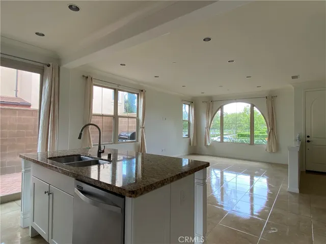 a kitchen with granite countertop a sink cabinets and window