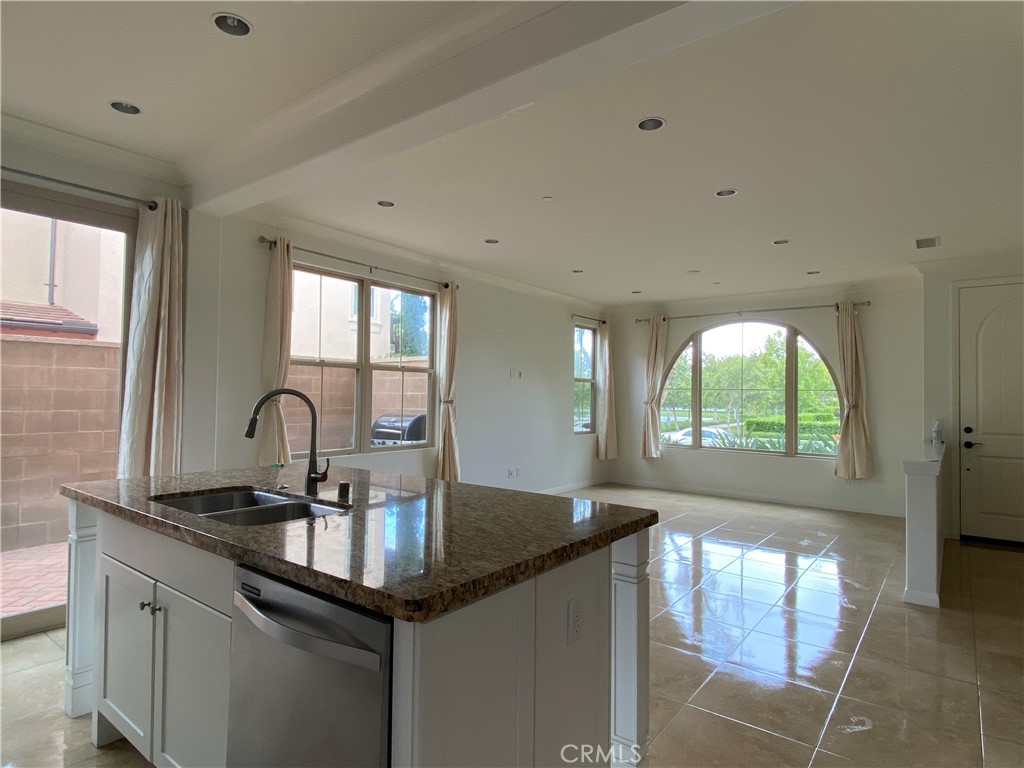32 Ovation Irvine, CA 92620 - Photo 8 of 18 a kitchen with granite countertop a sink cabinets and window