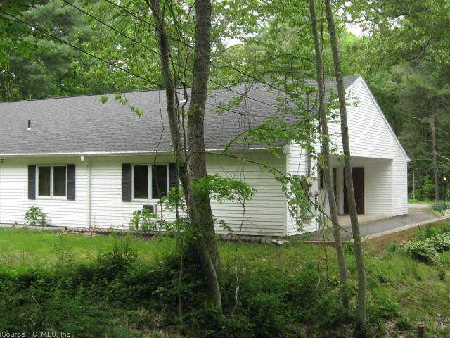 a view of house with backyard