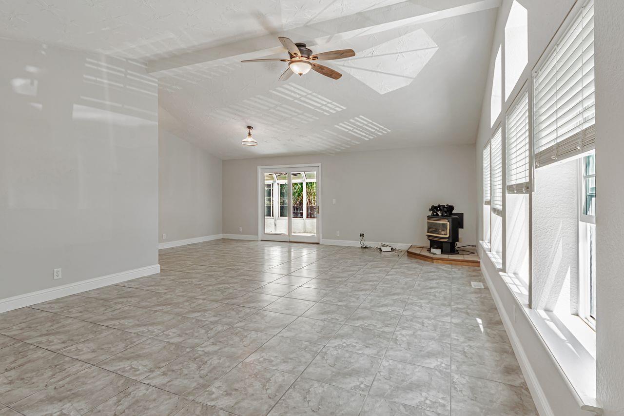 571 B Lane Applegate, CA 95703 - Photo 19 of 85 an empty room with windows and ceiling fan